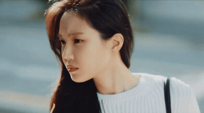 Woman With Long Hair In White Sweater And Black Bag GIF