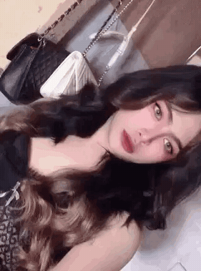 Woman With Long Hair Lying On Bed GIF
