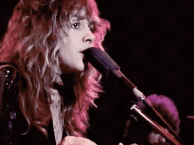 Woman With Long Hair Singing Into Microphone Playing Guitar GIF