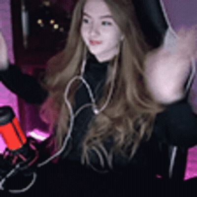 Woman With Long Hair Sitting At Microphone GIF