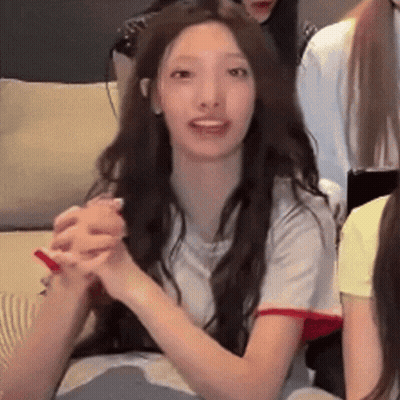 Woman With Long Hair Sitting On Couch Holding Hands GIF