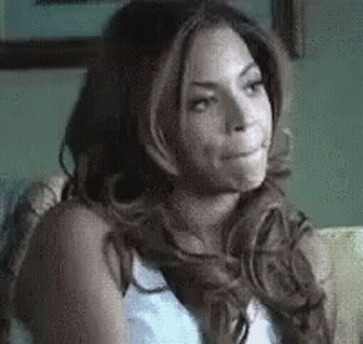 Woman With Long Hair Sitting On Couch Mouth Open GIF