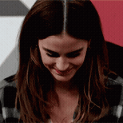 Woman With Long Hair Smiling In Plaid Shirt GIF