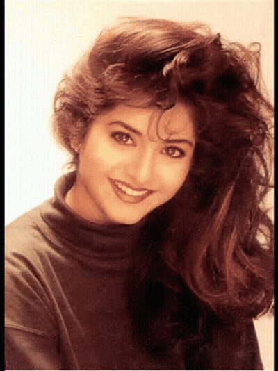 Woman With Long Hair Smiling In Turtleneck GIF