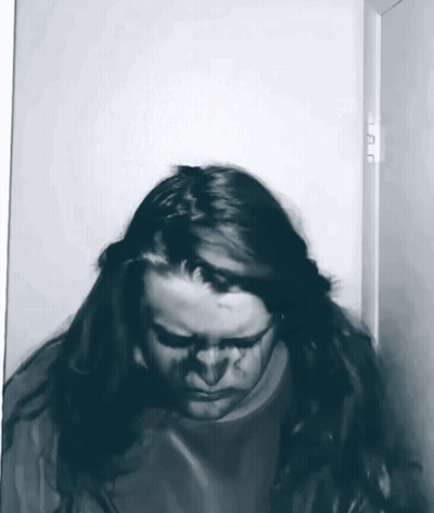 Woman With Long Hair Standing In Doorway GIF