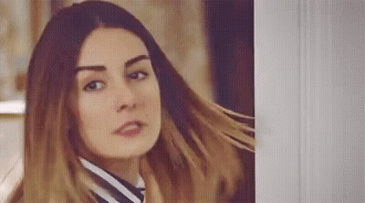 Woman With Long Hair Standing Next To Door GIF