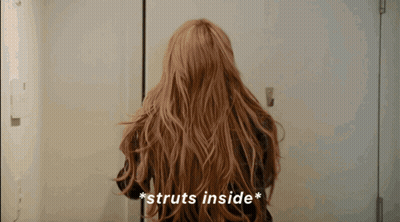 Woman With Long Hair Struts Inside Door