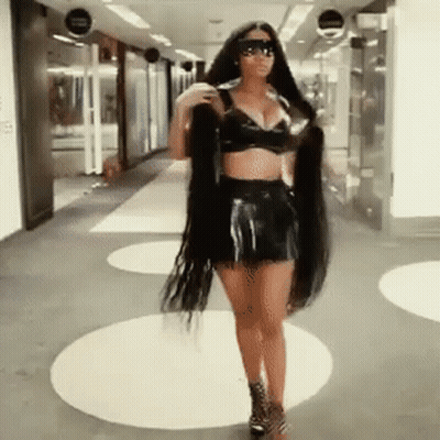 Woman With Long Hair Walking Down Hallway Wearing Sunglasses GIF