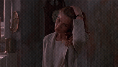 Woman With Long Red Hair And Earrings Looking Down GIF