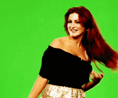 Woman With Long Red Hair And Green Background GIF