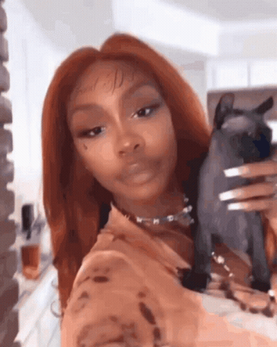 Woman With Long Red Hair Holding Black Cat GIF