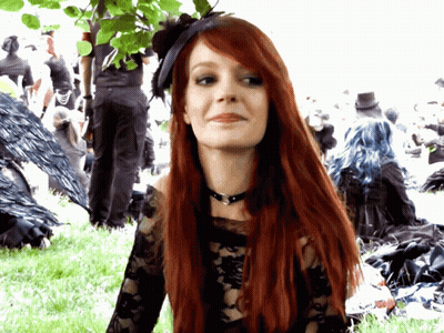 Woman With Long Red Hair In Black Top GIF