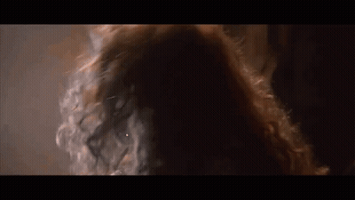 Woman With Long Red Hair In Dark Room GIF