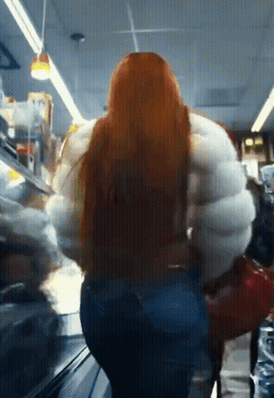 Woman With Long Red Hair In Large White Jacket GIF