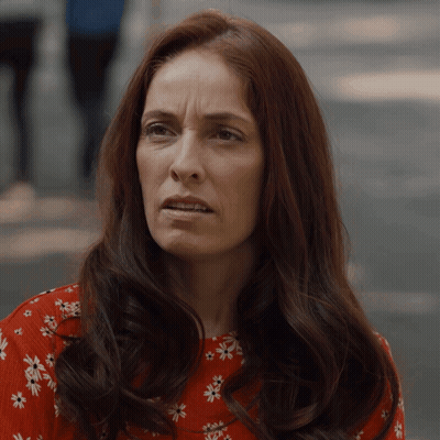 Woman With Long Red Hair In Red Floral Shirt GIF