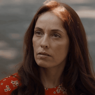 Woman With Long Red Hair In Red Floral Top GIF