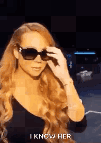 Woman With Long Red Hair In Sunglasses And Black Top GIF