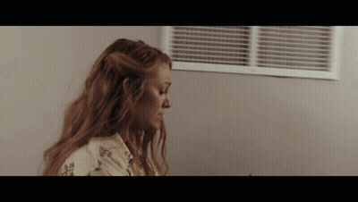 Woman With Long Red Hair Looking Down GIF