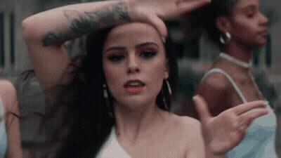 Woman With Long Red Hair Singing Into Microphone GIF
