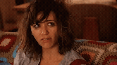 Woman With Messy Hair Sitting On Couch With Blanket GIF