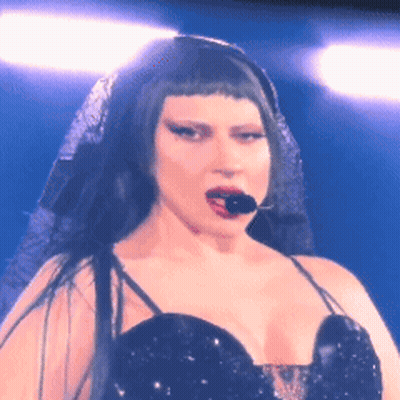 Woman With Microphone In Mouth Black Dress Veil GIF