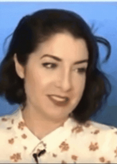 Woman With Microphone In Neck GIF