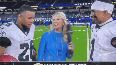 Woman With Microphone Talking To Football Players Number 20 GIF