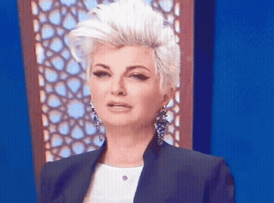 Woman With Mohawk And Earrings Making Funny Face GIF