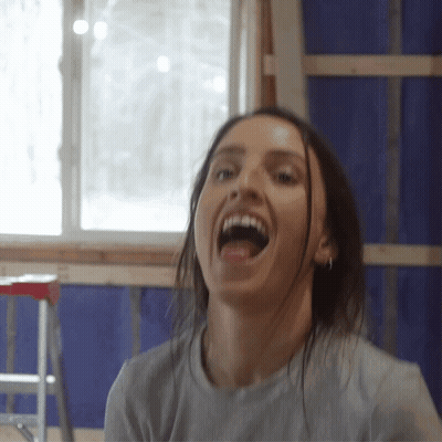 Woman With Mouth Open And Ladder Behind GIF