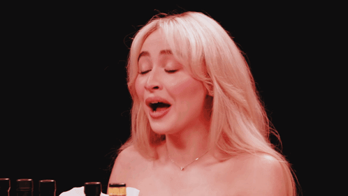 Woman With Mouth Open In Front Of Beer Bottle GIF