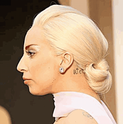 Woman With Neck And Ear Tattoo Close Up GIF