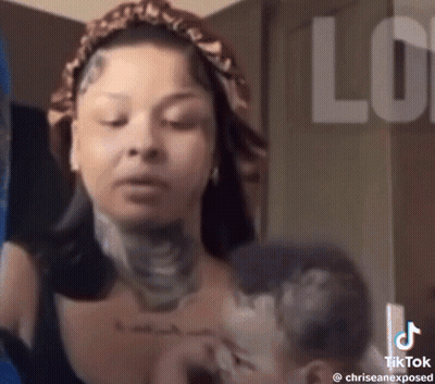 Woman With Neck Tattoo Holding Child GIF