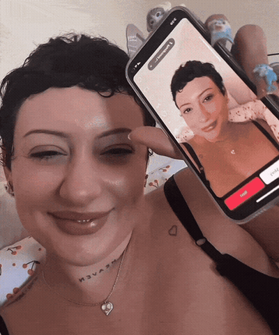 Woman With Neck Tattoo Holding Phone With Another Woman GIF