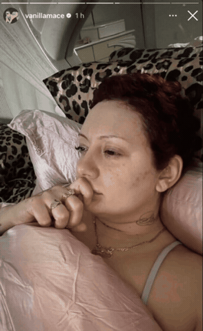 Woman With Neck Tattoo Laying In Leopard Print Blanket GIF