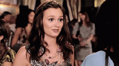 Woman With Necklace And Braided Hair In Crowd GIF