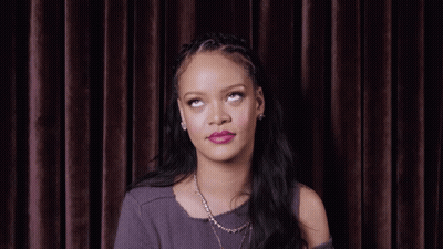 Woman With Necklace And Braided Headband Looking Up GIF