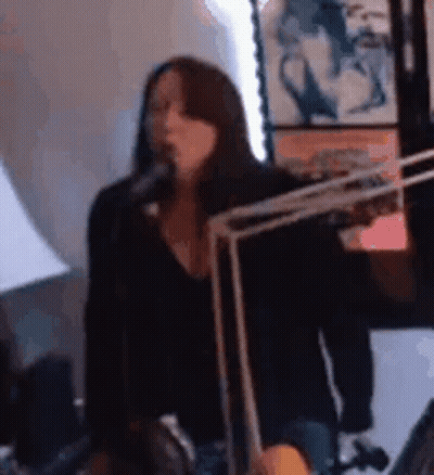 Woman With Necklace And Earrings Next To Man In Blue Jacket GIF
