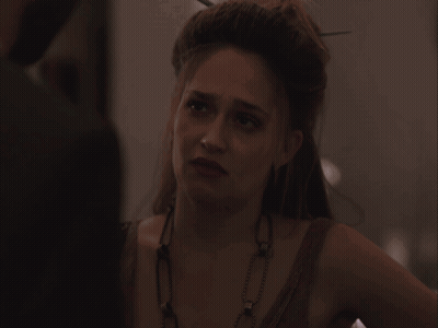 Woman With Necklace Looking At Camera GIF