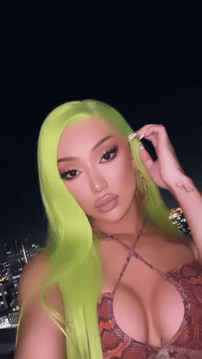 Woman With Neon Green Hair In Snake Print Top GIF