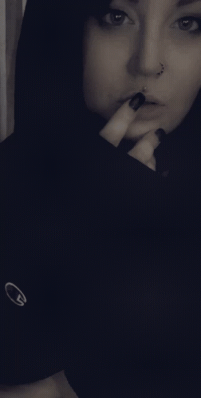 Woman With Nose Ring, Black Nails, Black Nike Shirt GIF