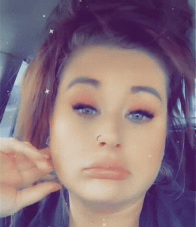 Woman With Nose Ring Making Funny Face In Back Seat GIF