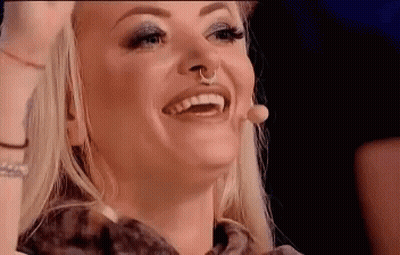 Woman With Nose Ring Smiling And Laughing At Microphone GIF