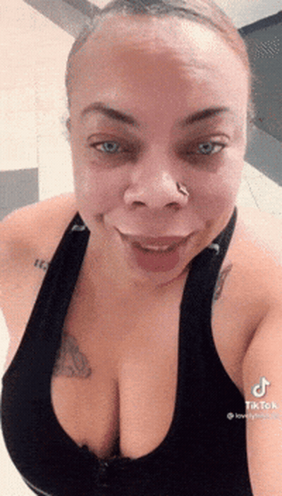 Woman With Nose Ring Smiling In Black Tank Top GIF