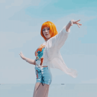 Woman With Orange Hair In White Shirt And Shorts GIF