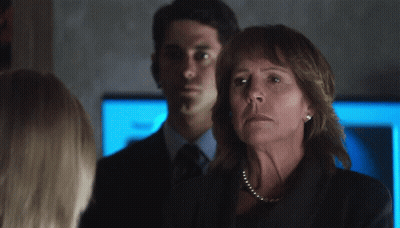 Woman With Pearl Necklace In Front Of Man GIF