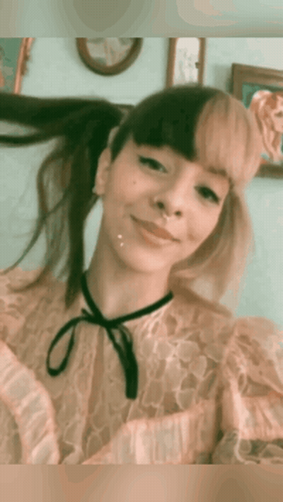 Woman With Pigtails And Nose Ring Smiling GIF