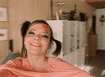 Woman With Pigtails Bloody Face Smiling GIF