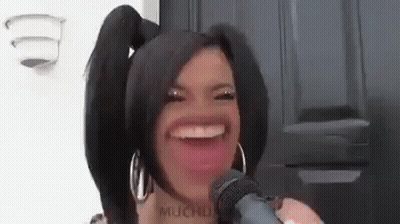 Woman With Pigtails Making Funny Face Holding Microphone GIF