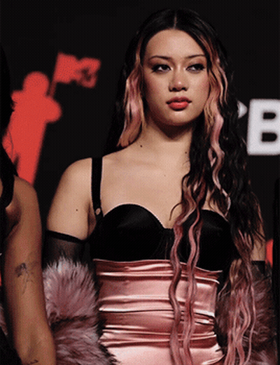 Woman With Pink And Black Hair In Black Top GIF
