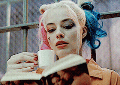 Woman With Pink And Blue Hair Reading Book Drinking Cup GIF